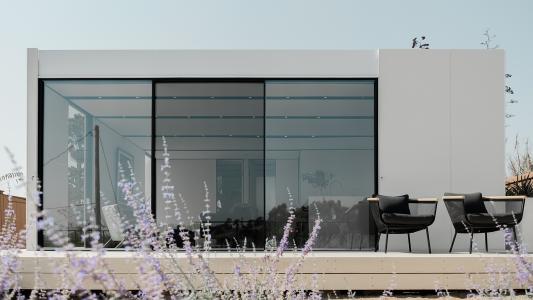 a sleek Cover unit with a patio and flowers in the foreground