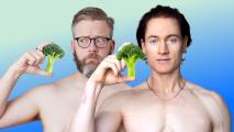 Two men holding broccoli in their hands.