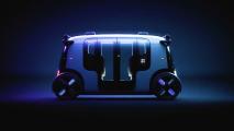A futuristic car is shown in a dark room.