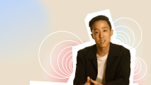 A man is sitting in front of a colorful background.