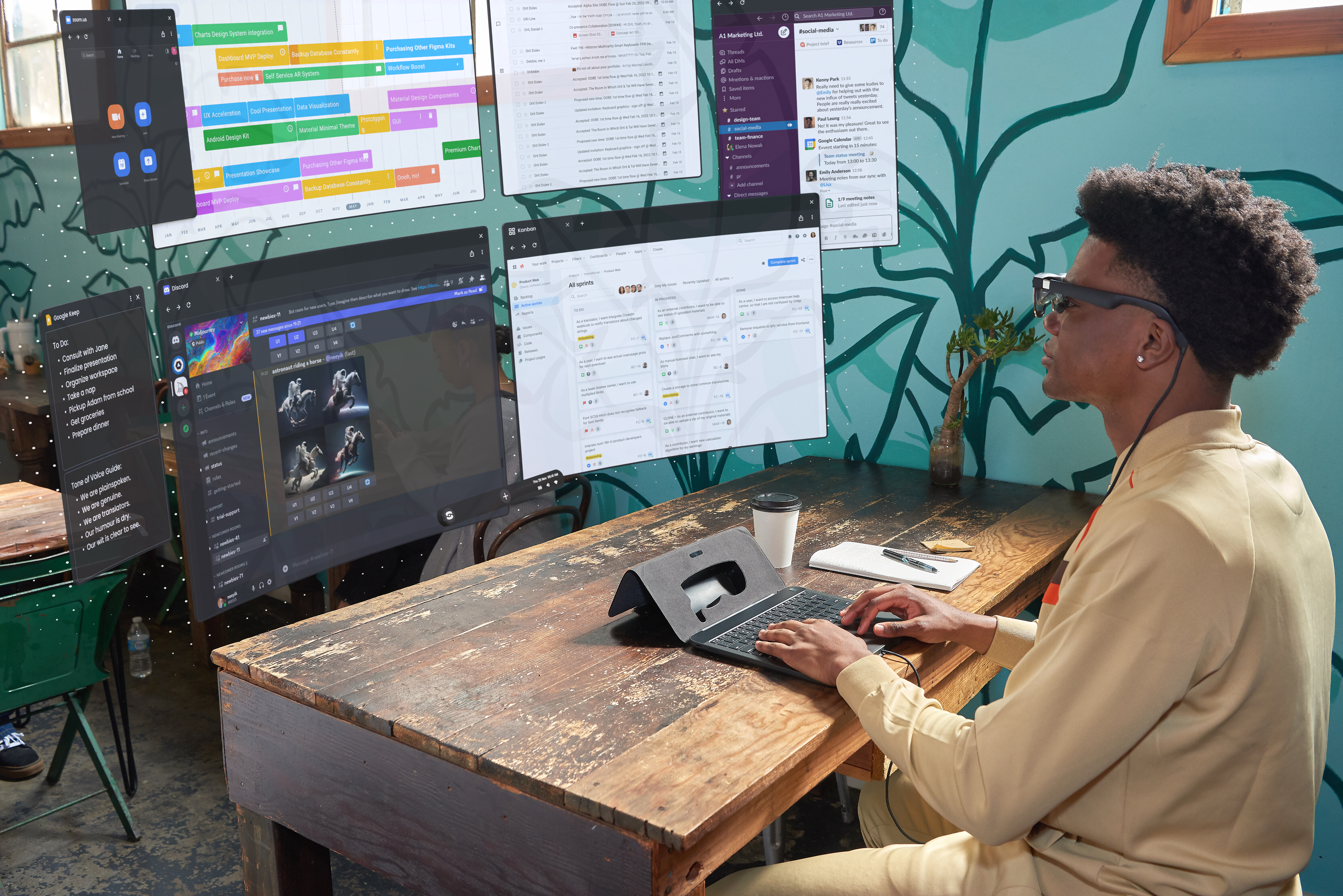a person at a desk using a Spacetop looking at several large virtual screens